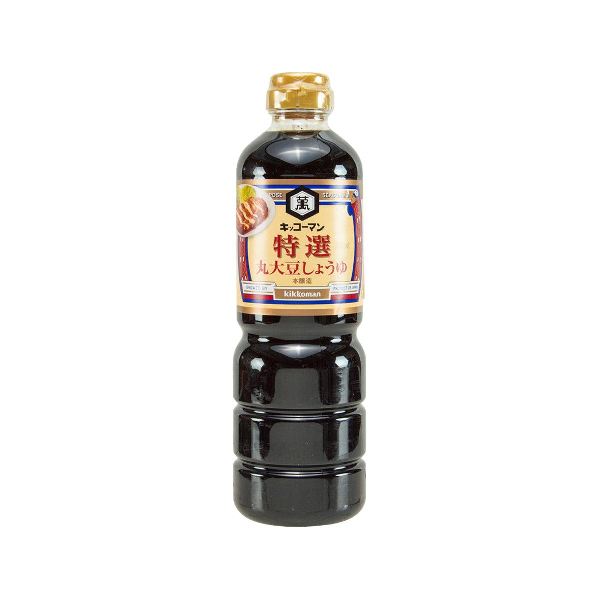KIKKOMAN premium whole soybeans soy sauce bottle with gold cap and dark brown liquid