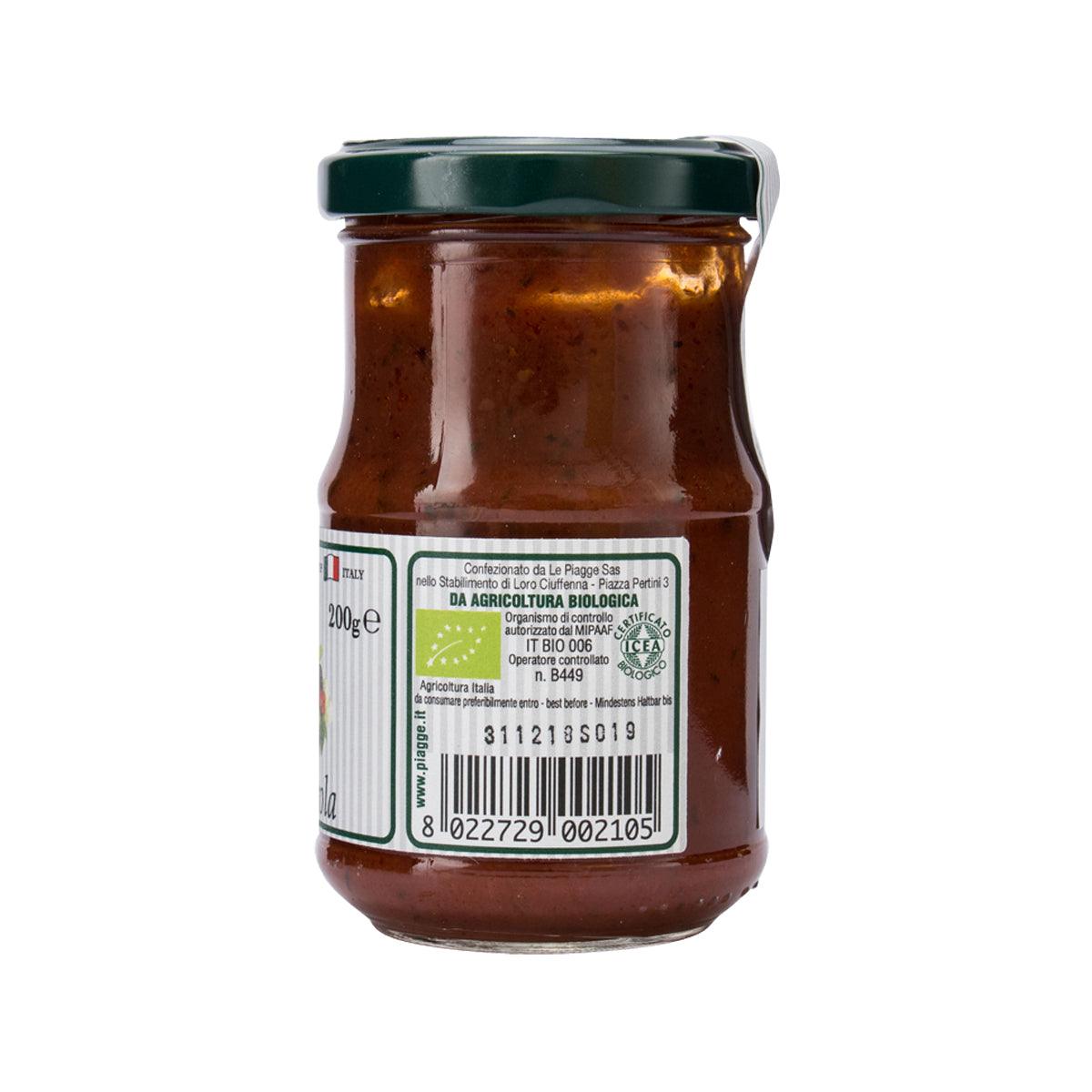 Tomato sauce jar with dark red sauce, side label with organic certification and barcode