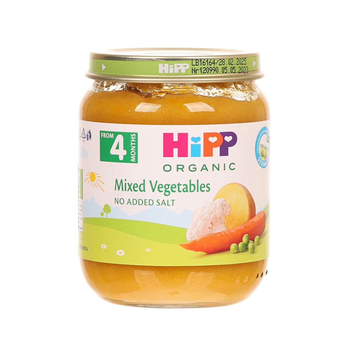 Organic mixed vegetable baby food jar with green lid, orange puree visible