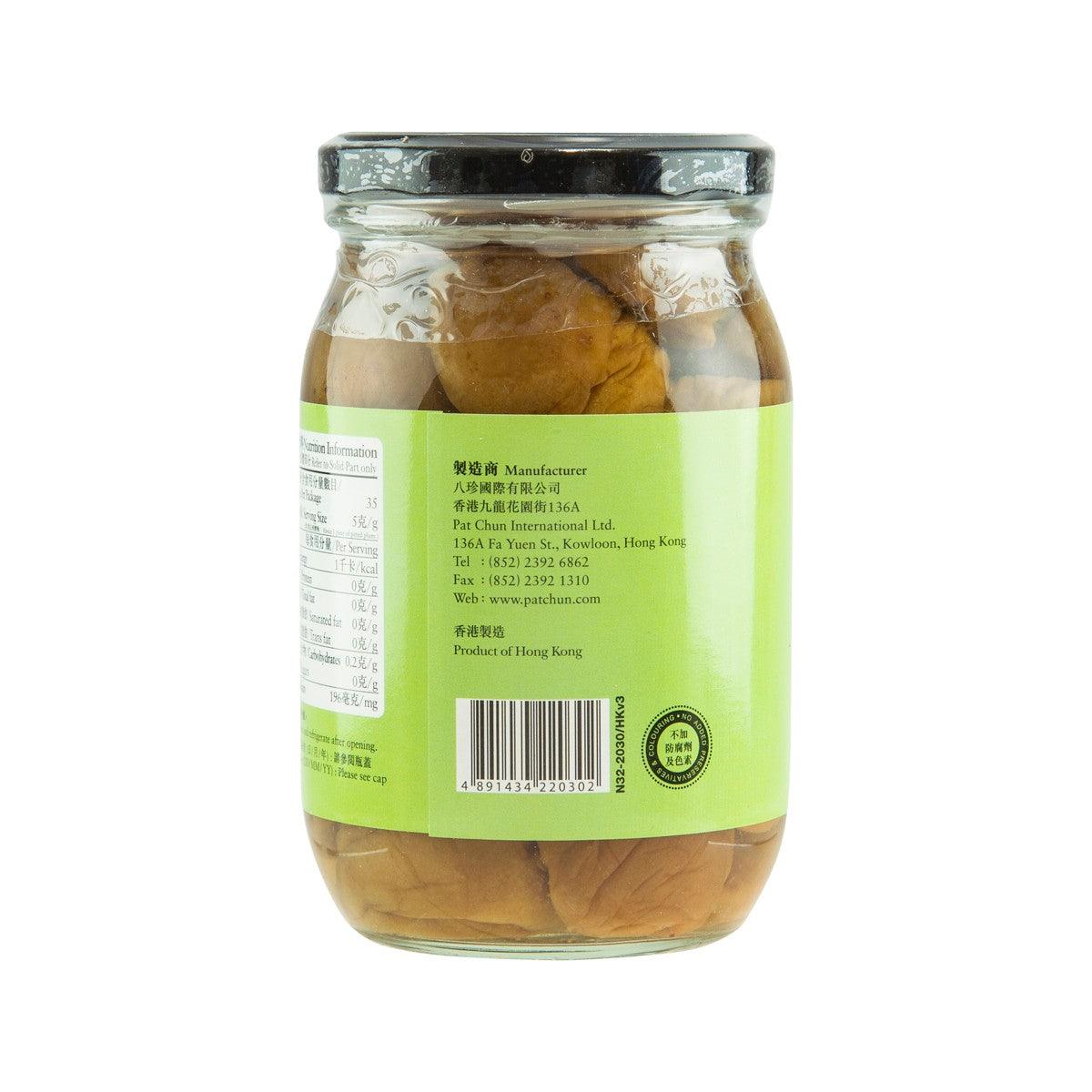 Pickled plum jar with back label on green label, clear glass with plums in brine