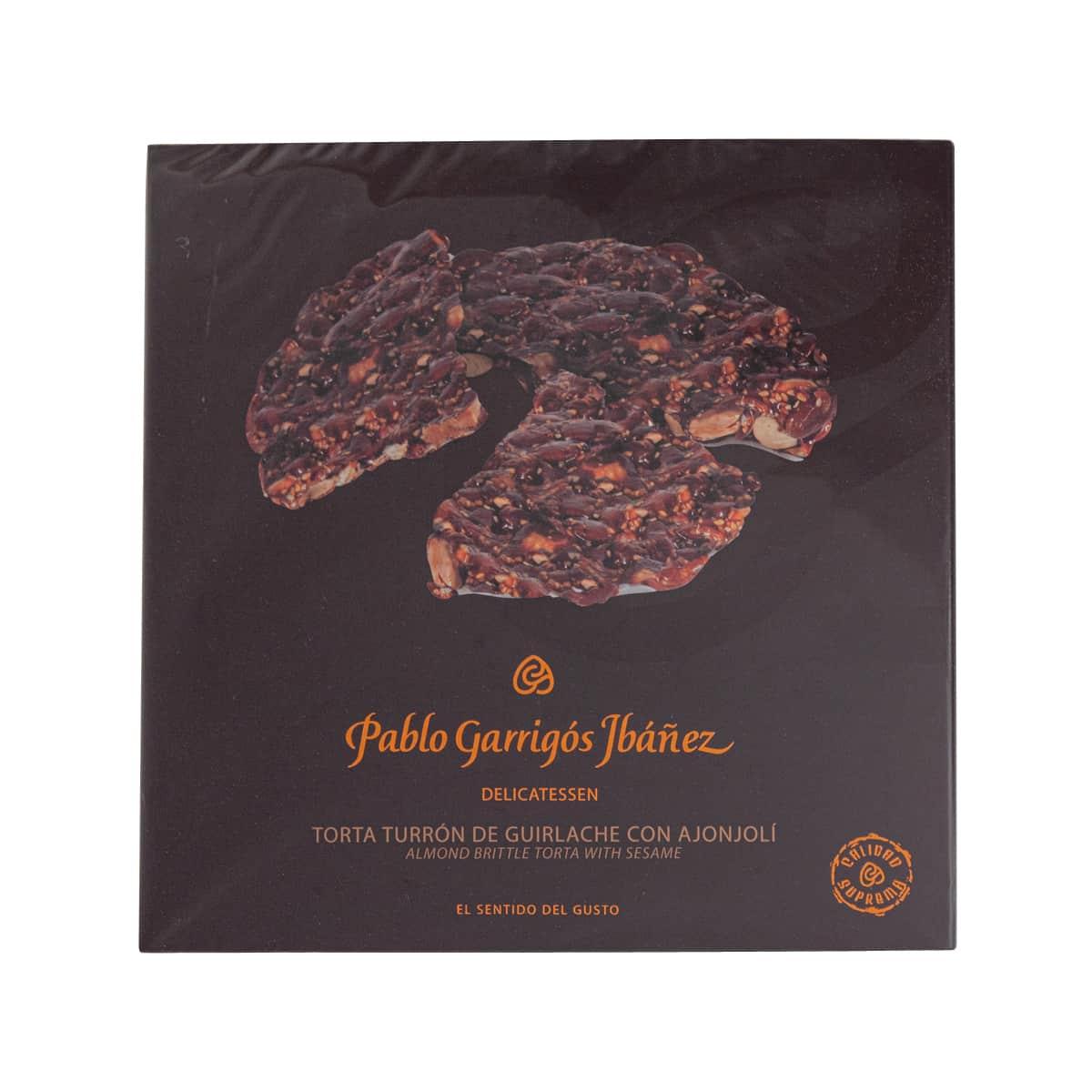Almond brittle nougat with sesame in sealed package, dark wrapper and label