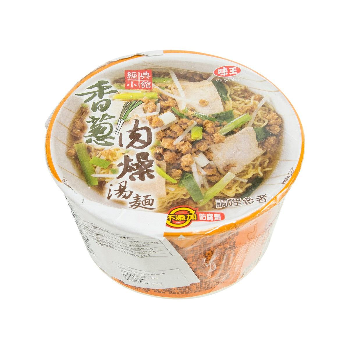 Instant noodle cup with visible broth, noodles, and pork toppings