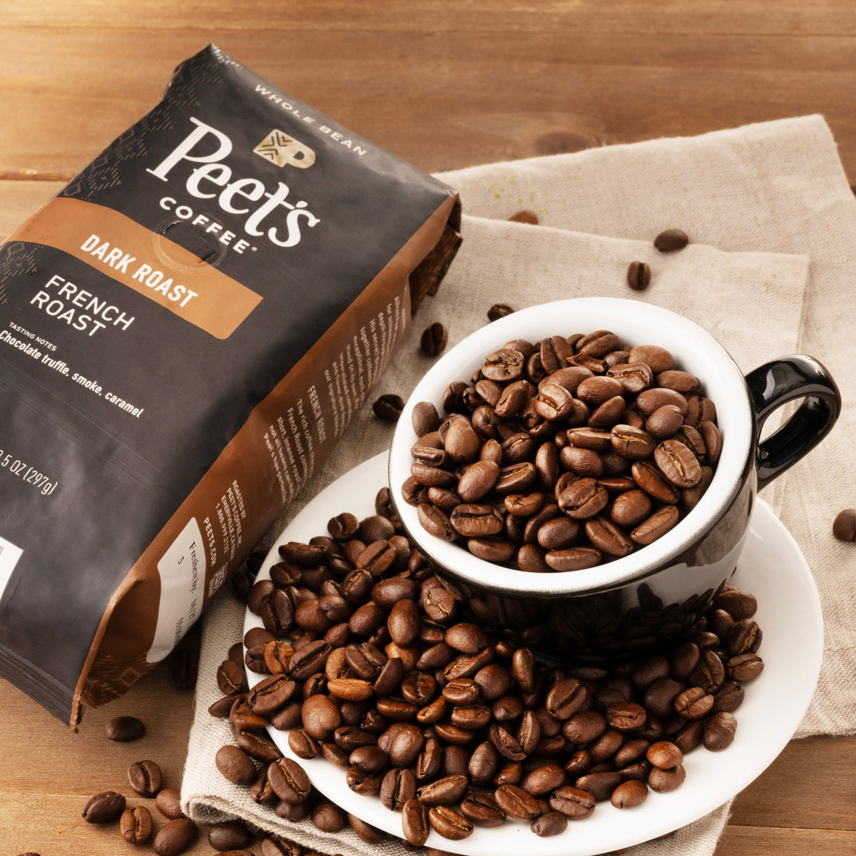 Peet's dark roast French roast whole bean coffee bag with roasted coffee beans and scoop