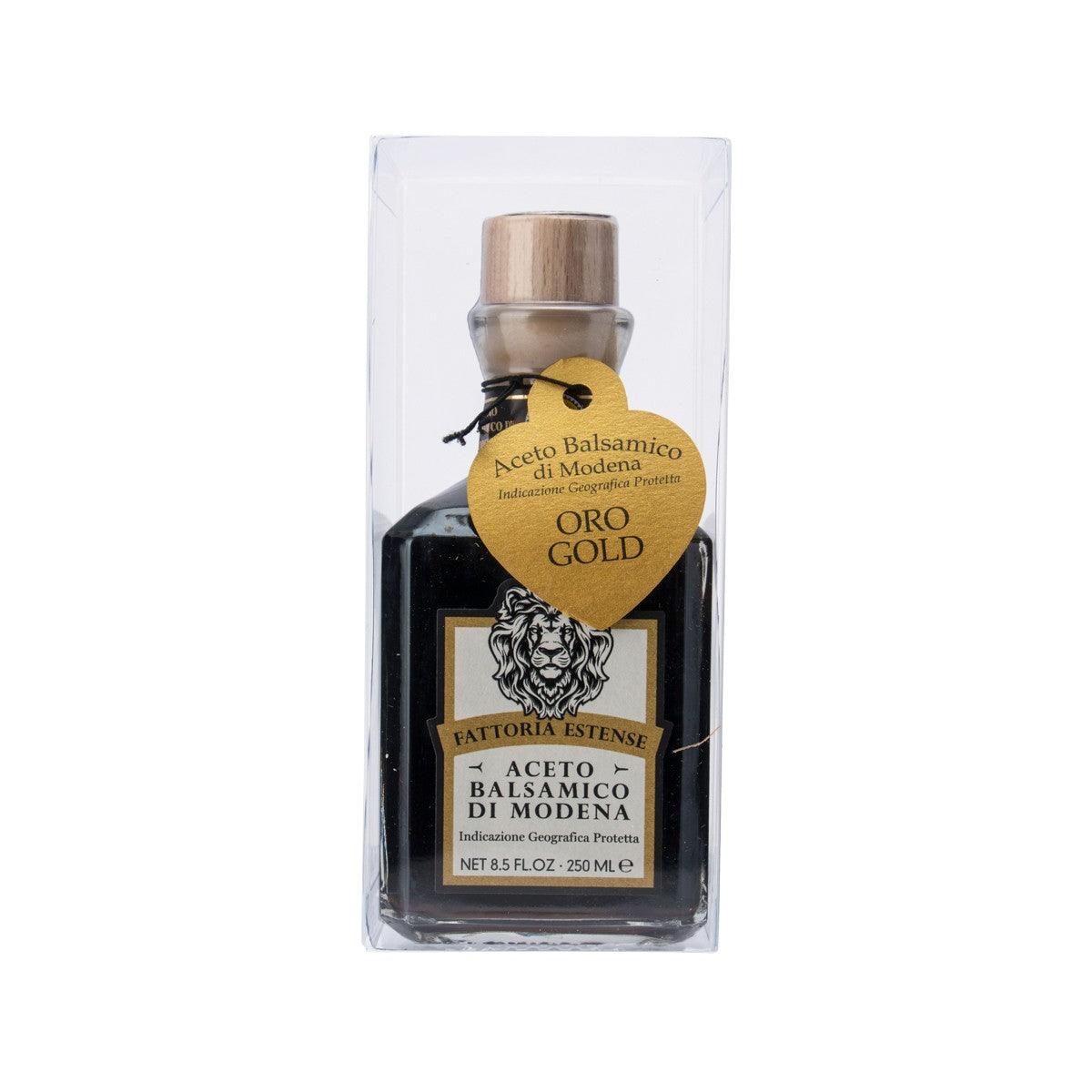 Gold balsamic vinegar bottle with cork top, front label in clear box