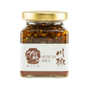 Sichuan spicy sauce jar with gold cap and dark chili condiment