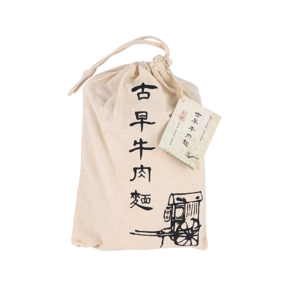 Beige fabric drawstring pouch with printed Chinese text and attached label tag