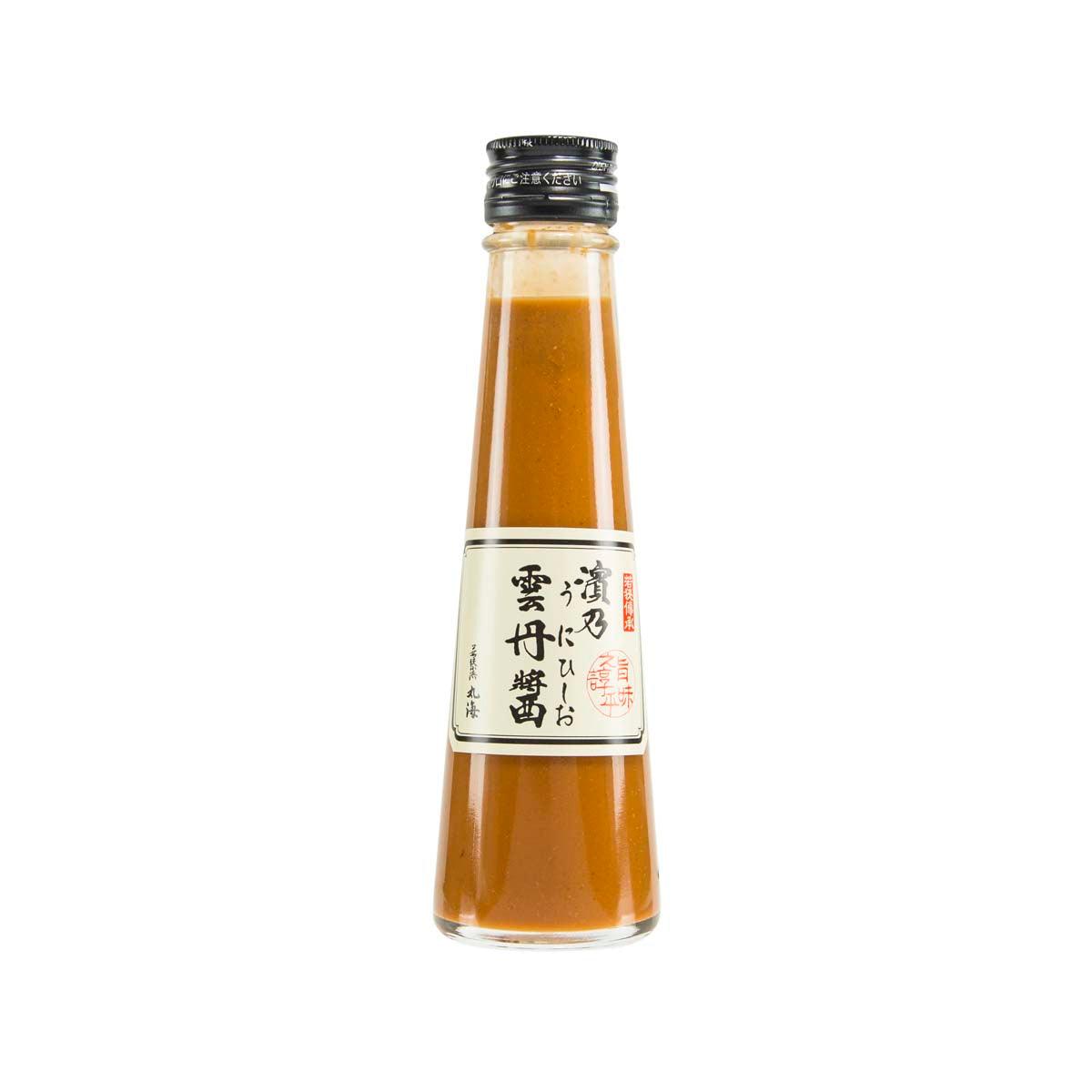 Amber salted sea urchin sauce in glass bottle with metal cap and front label