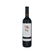 Wine bottle with dark glass, black cap, and floral front label