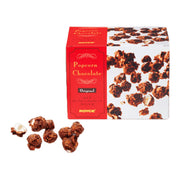 Chocolate popcorn candy gift box with red ROYCE' label and scattered coated pieces