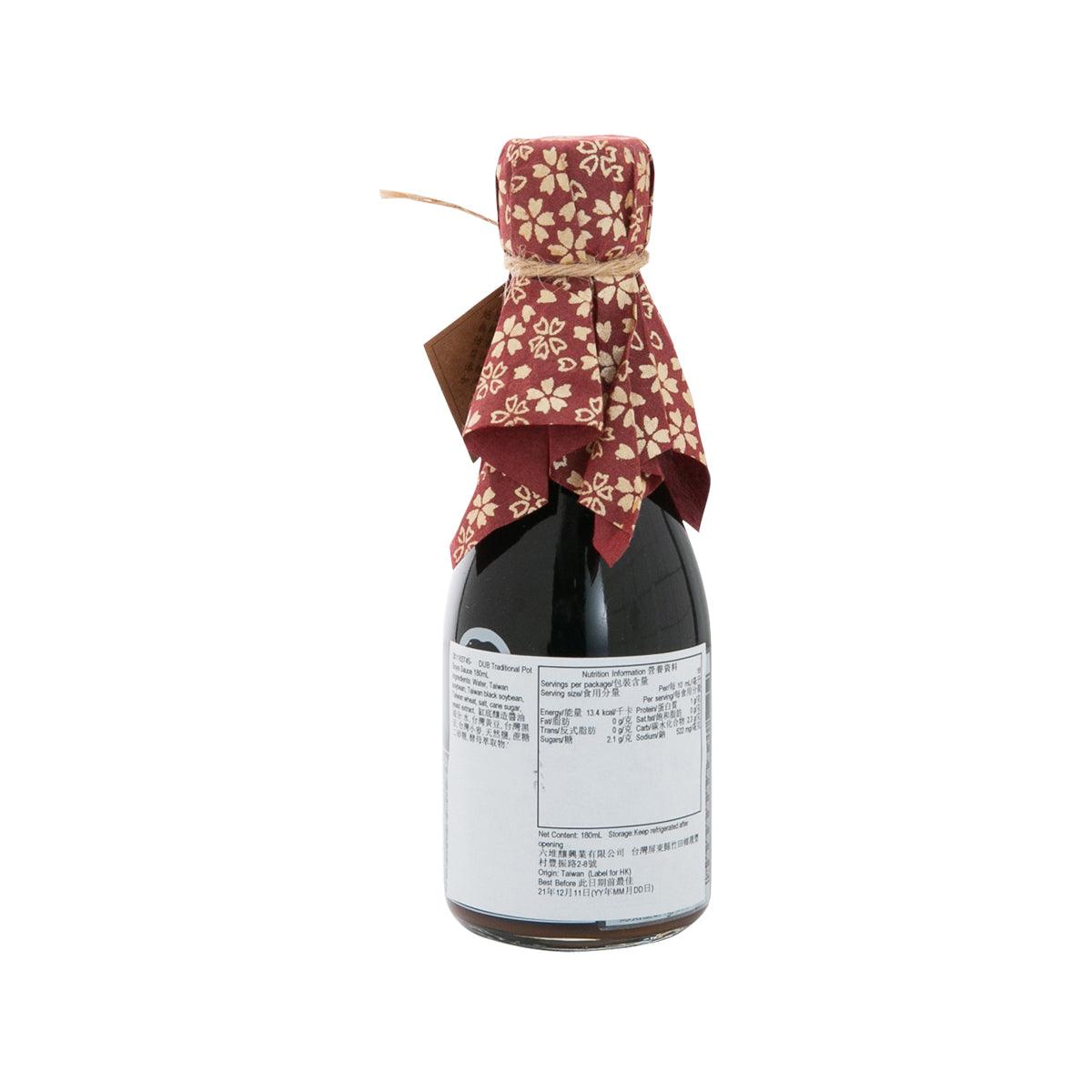 Soy sauce bottle with maroon floral fabric drape over dark bottle, back label visible.