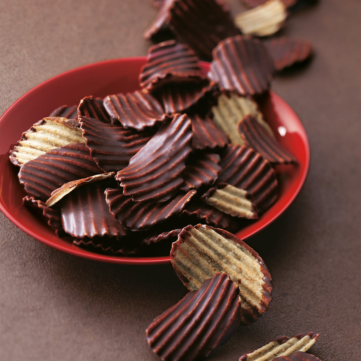 Mild bitter chocolate potato chips on a red plate