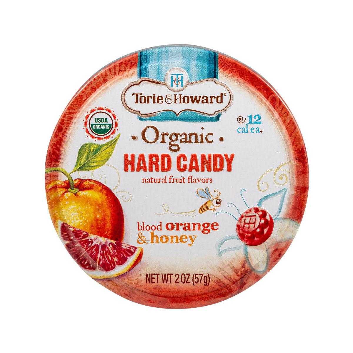 Round hard candy tin label with orange and honey flavor artwork and net wt 57g