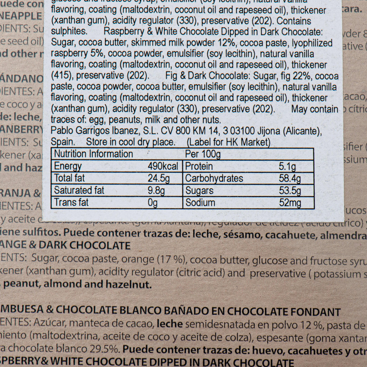 Assorted fruit chocolates ingredients label close-up with allergen and nutrition text