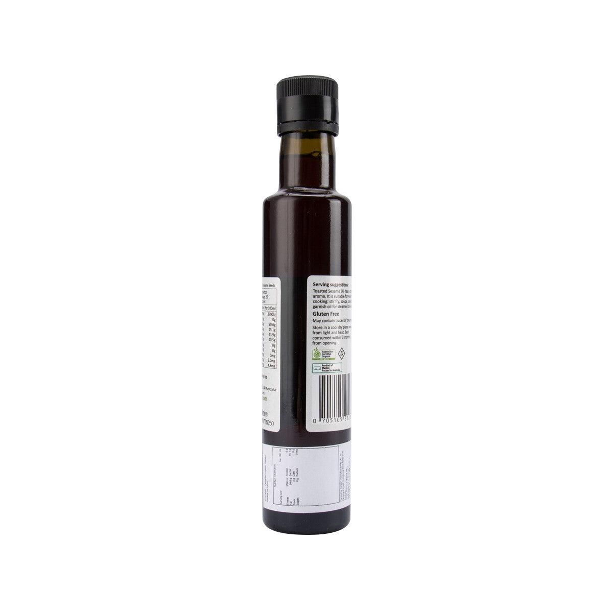 Toasted sesame oil bottle, dark glass with black cap; back ingredient label