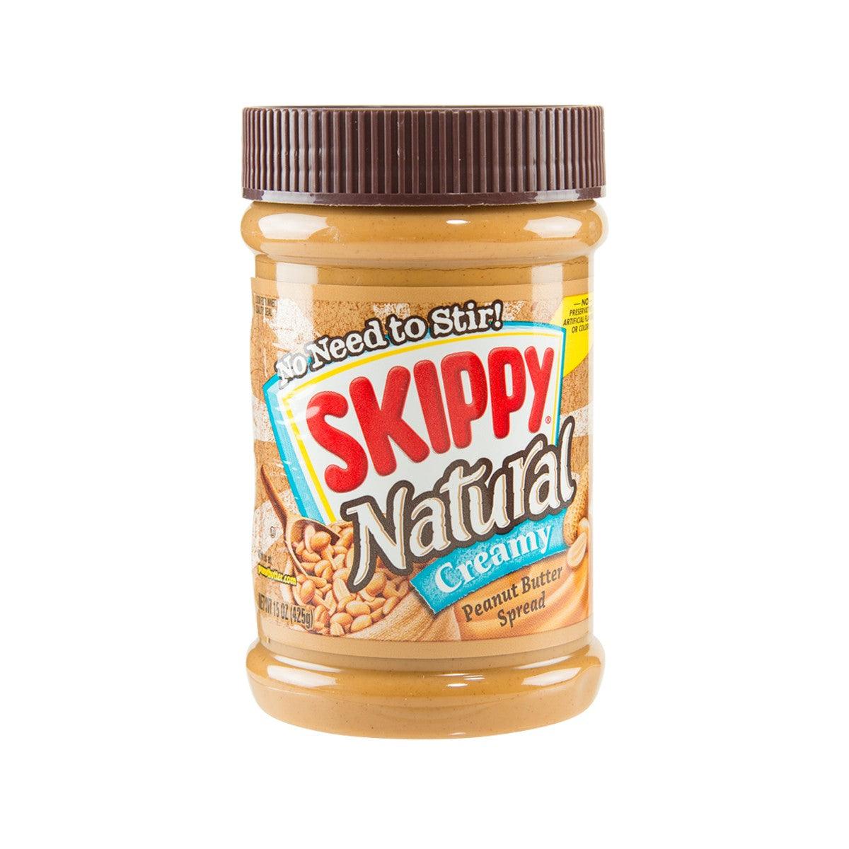 Creamy natural peanut butter spread jar with brown ribbed cap and SKIPPY label