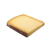 Aged raw milk Comte cheese wedge, brown rind and pale yellow interior