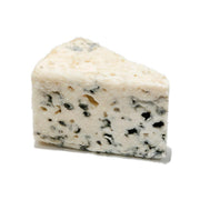 Roquefort cheese wedge with creamy white interior and blue mold veins