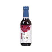 Yamanashi grape cider bottle with blue cap, dark glass, fruit-themed label