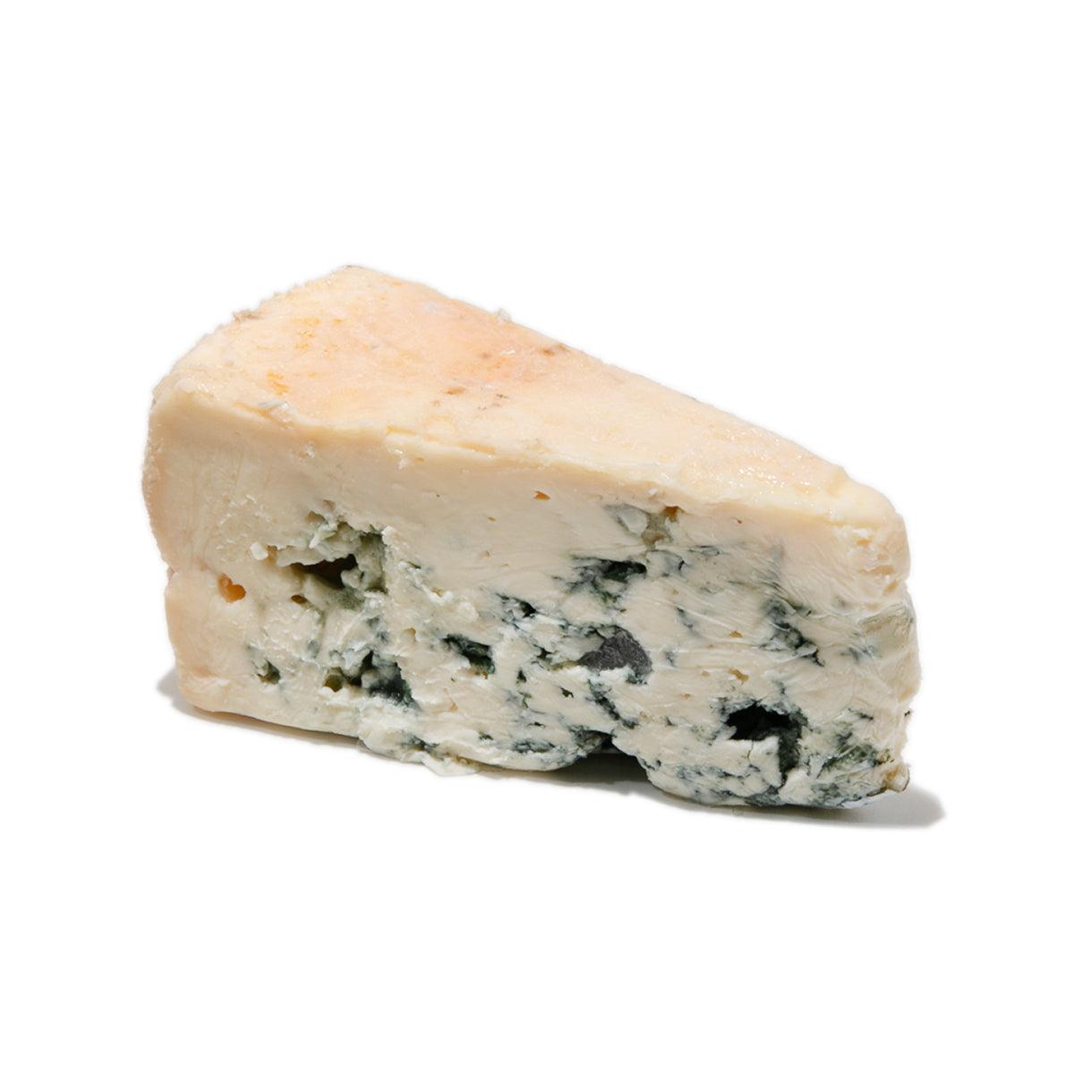 Blue-veined cheese wedge, creamy off-white with green and blue mold spots