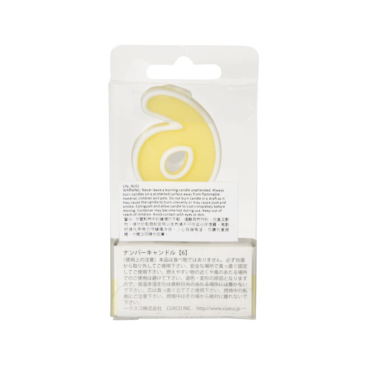 Number 6 candle on stand, yellow wax visible through clear packaging