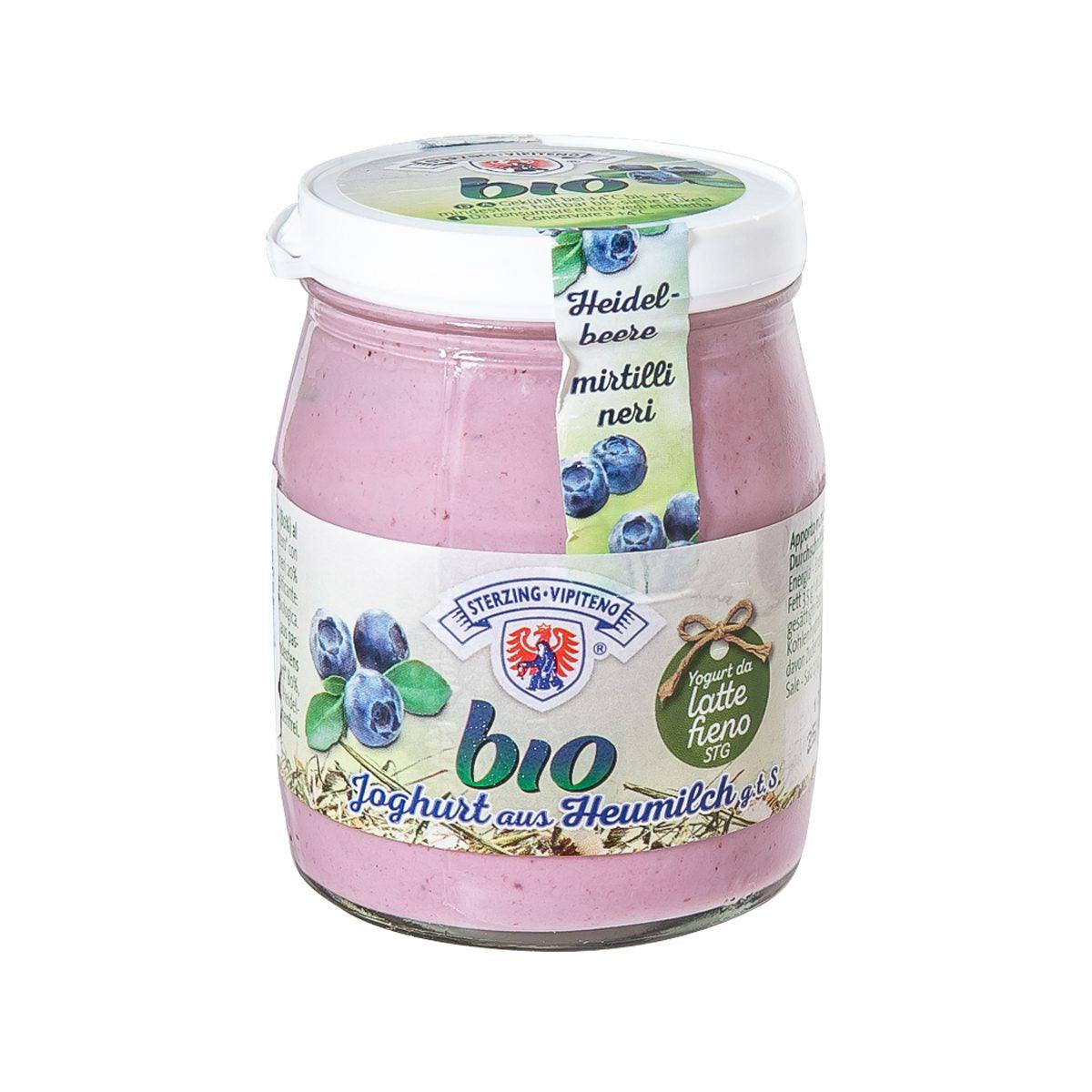 Organic blueberry yogurt in glass jar with white lid, pink label