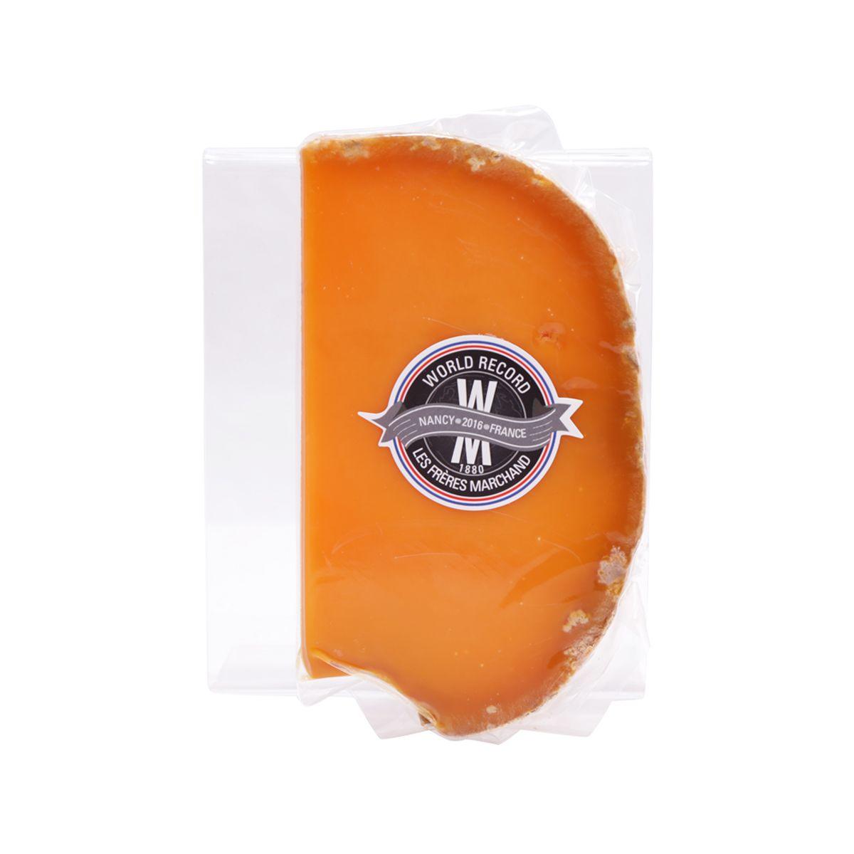 Aged Mimolette cheese wedge in clear wrapper with LES FRERES MARCHAND round label