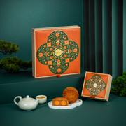Traditional mooncake gift box with orange and green festive design and white tray