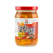 Spicy fermented tofu jar with red lid, orange chili bean curd in glass container