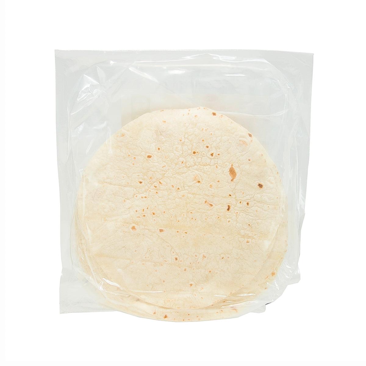 Plain unleavened chapatti flatbread, round pale flatbread in clear bag