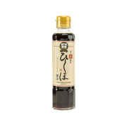Raw soy sauce in clear glass bottle with gold screw cap and label