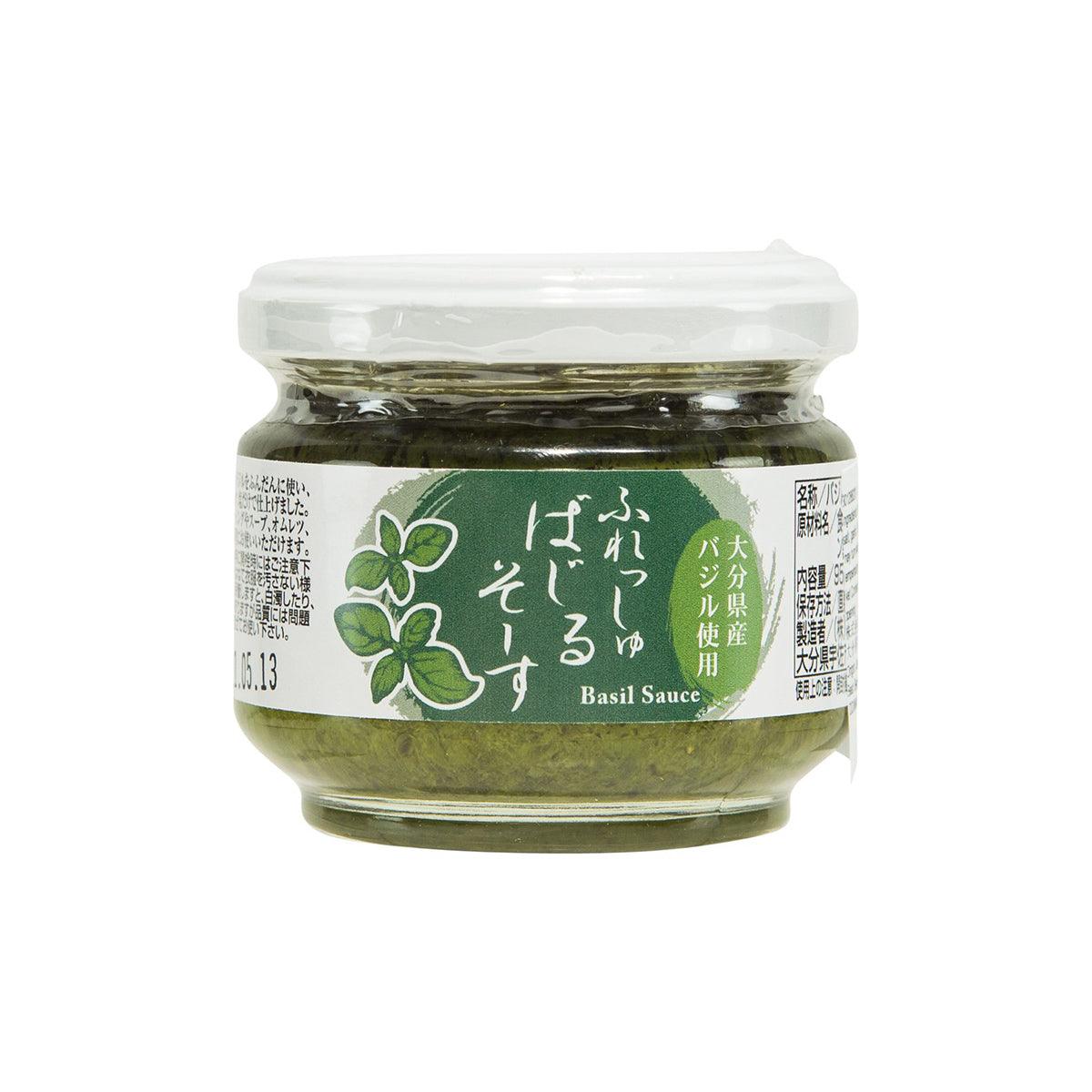 Herb sauce jar with green basil sauce in clear glass and white lid