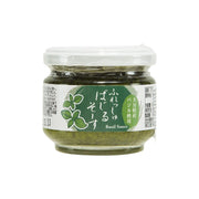 Herb sauce jar with green basil sauce in clear glass and white lid