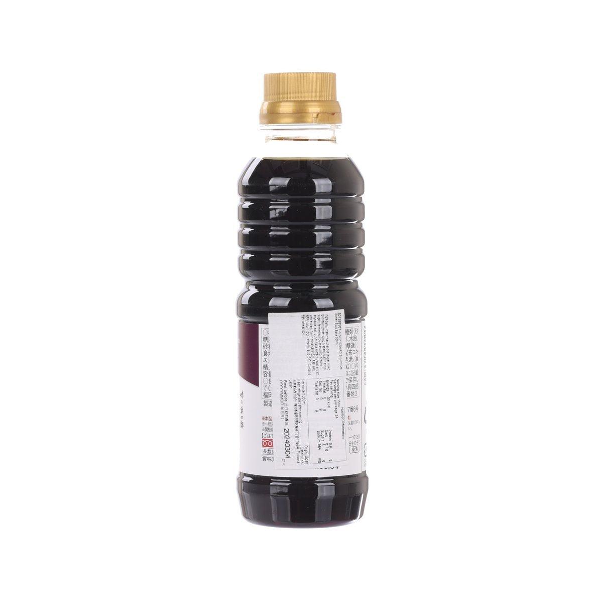 Dark soy-based soup base bottle with gold cap, back label with product info visible