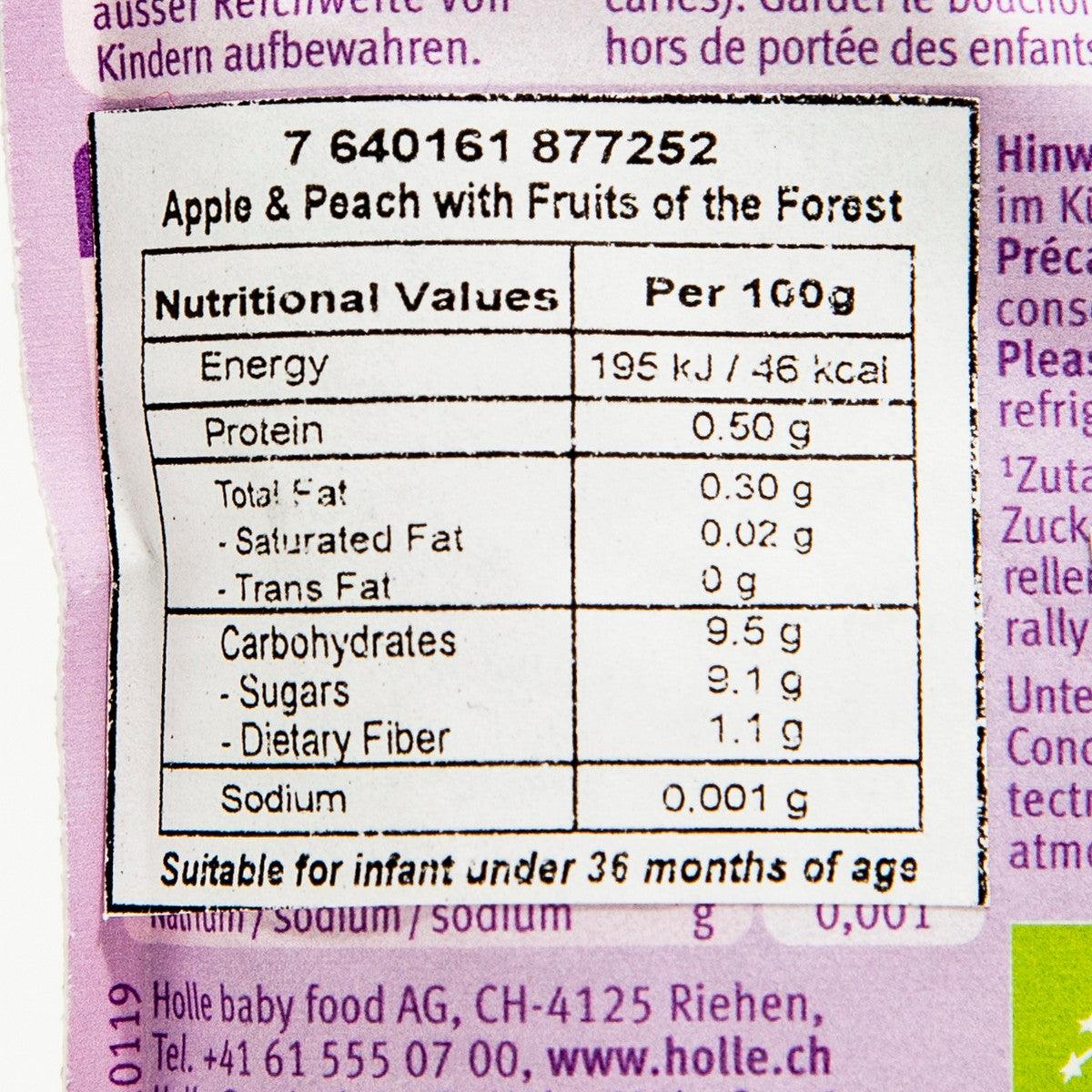 Nutrition facts panel for apple and peach puree with fruits of the forest, close-up