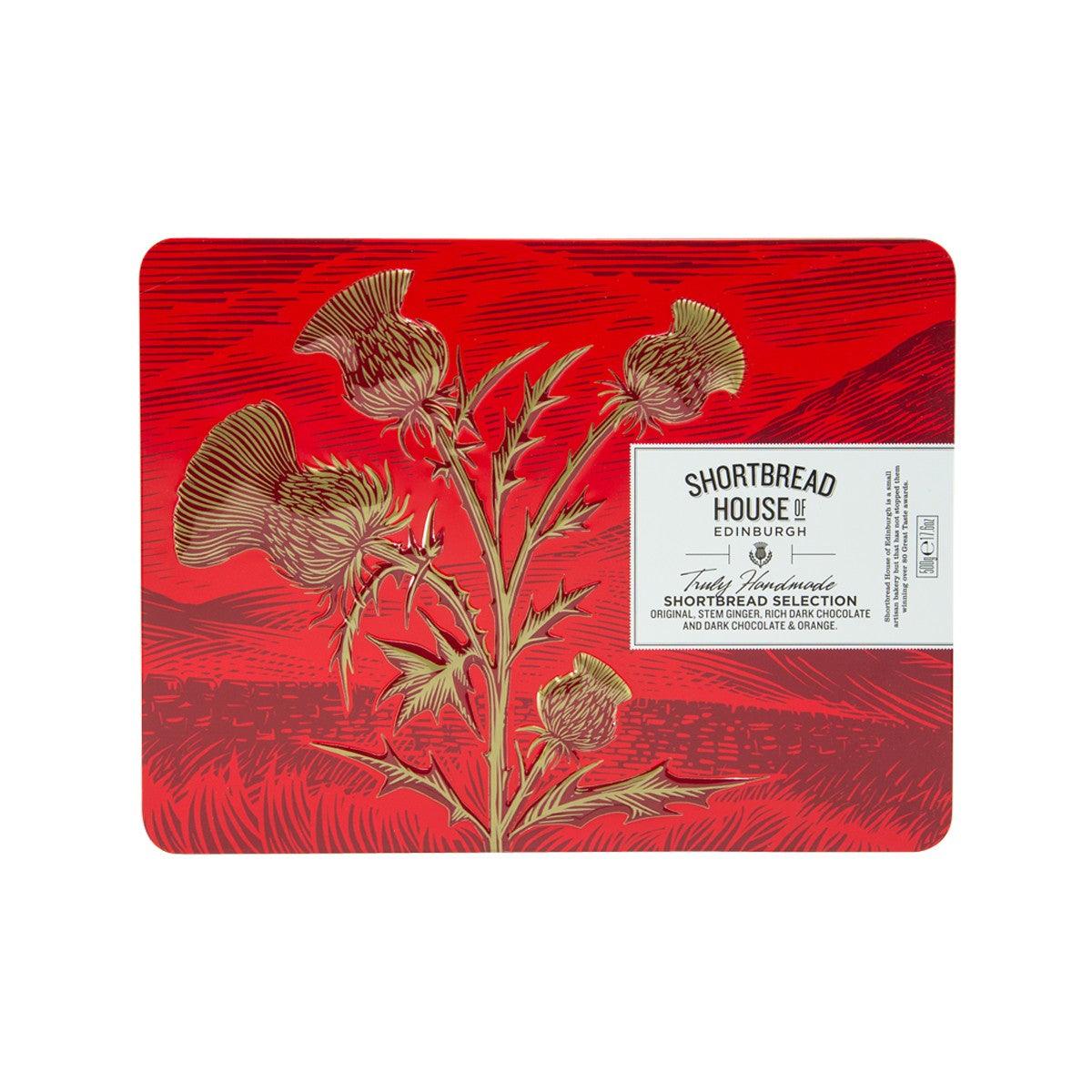 Red decorative shortbread tin with floral pattern and label, House of Edinburgh