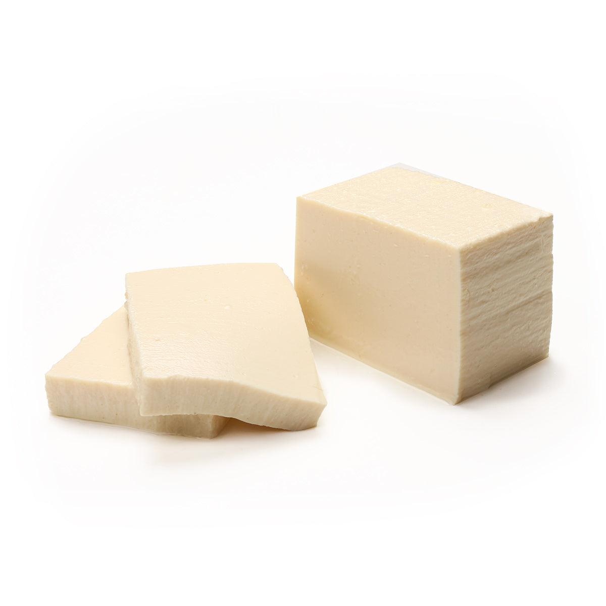Large soft tofu blocks, one cut piece and one full block