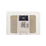Packaged black sesame soft tofu in clear wrap, rectangular blocks