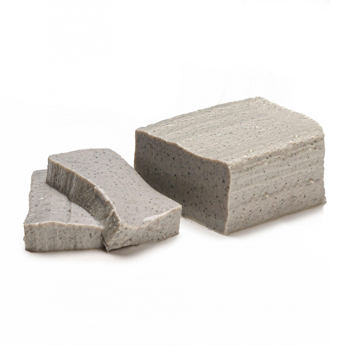 Soft black sesame tofu blocks and a small wedge, textured light gray