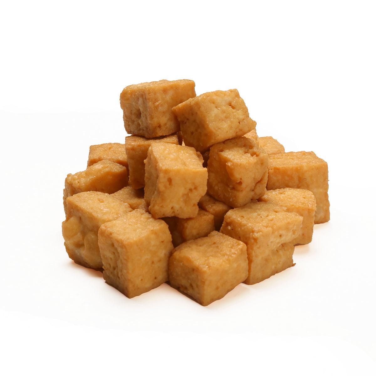 Stack of small deep fried tofu cubes, golden brown
