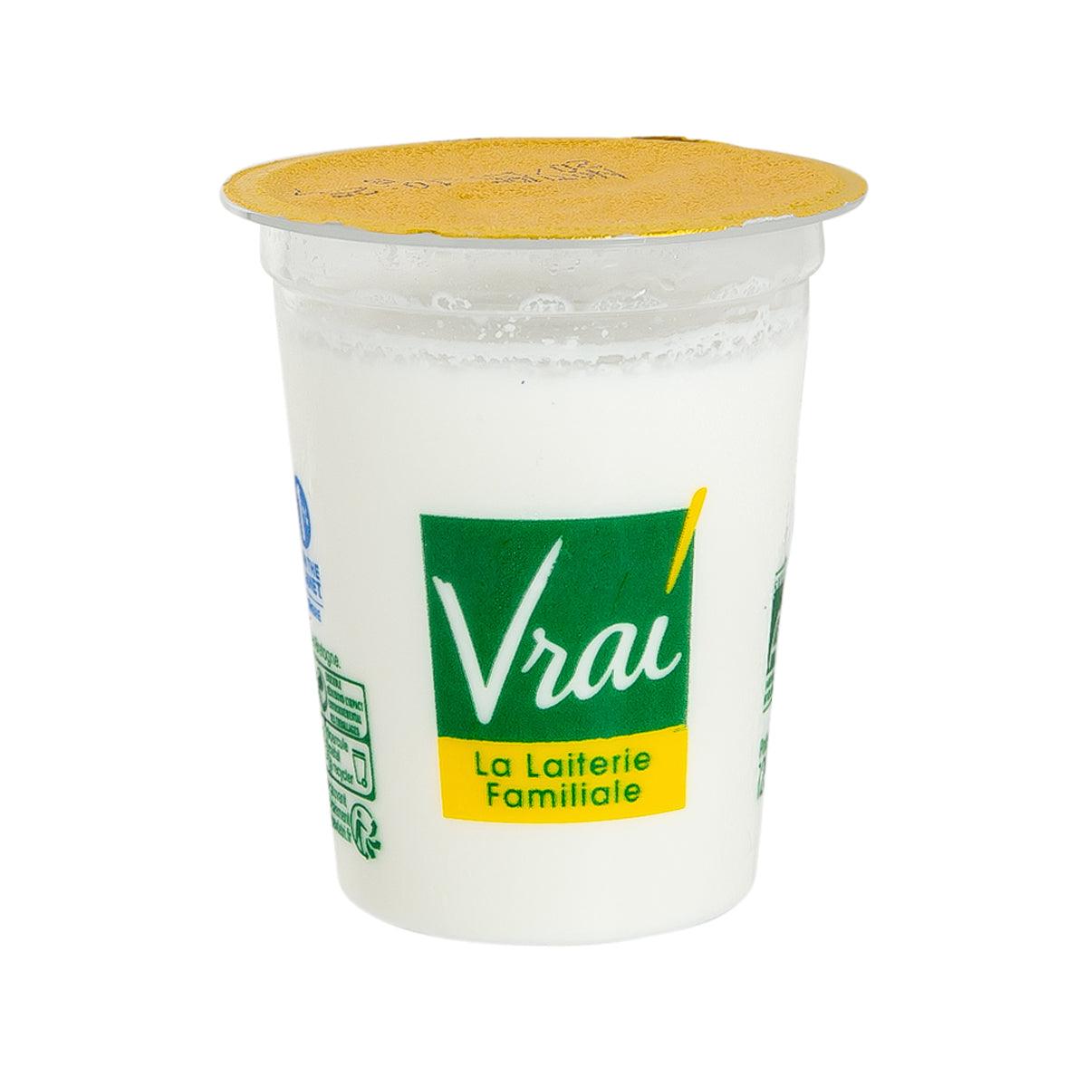 Goat milk yogurt cup with golden lid and green Vrai label on white container
