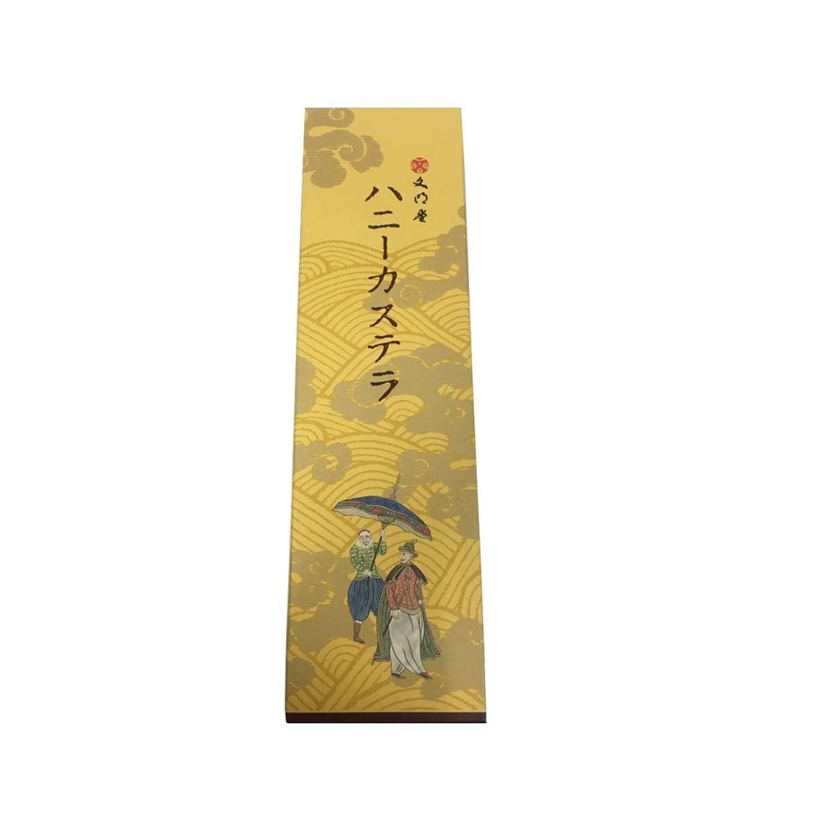 Gold paper snack package with illustrated figure and Japanese text, for honey castella