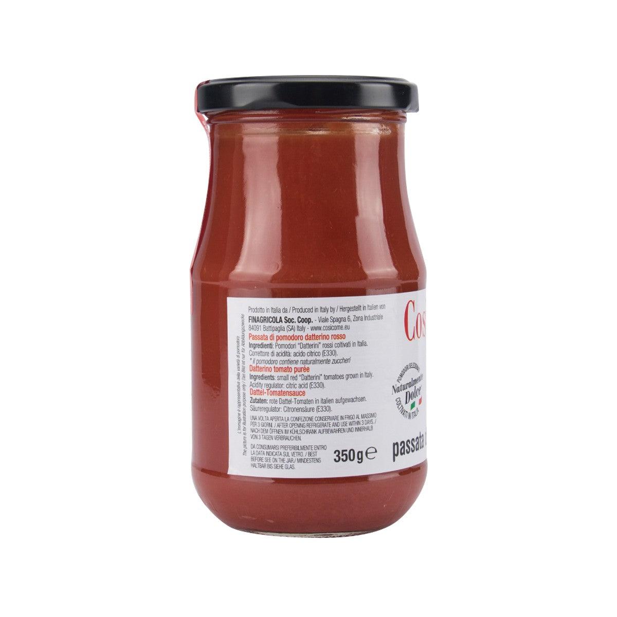 Jar of red tomato puree with black lid, nutrition panel side view