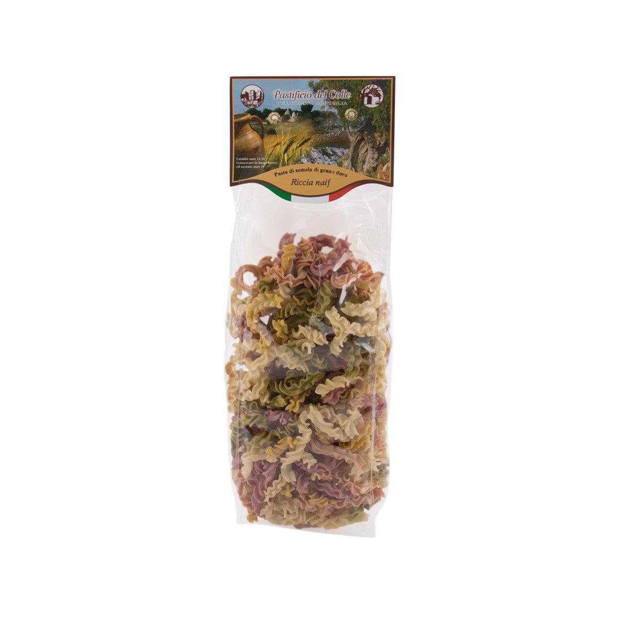 Artisanal colorful riccia naif pasta in clear bag, curled tri-color pieces
