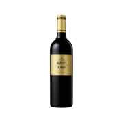 Wine bottle with dark glass, gold cap, and cream label