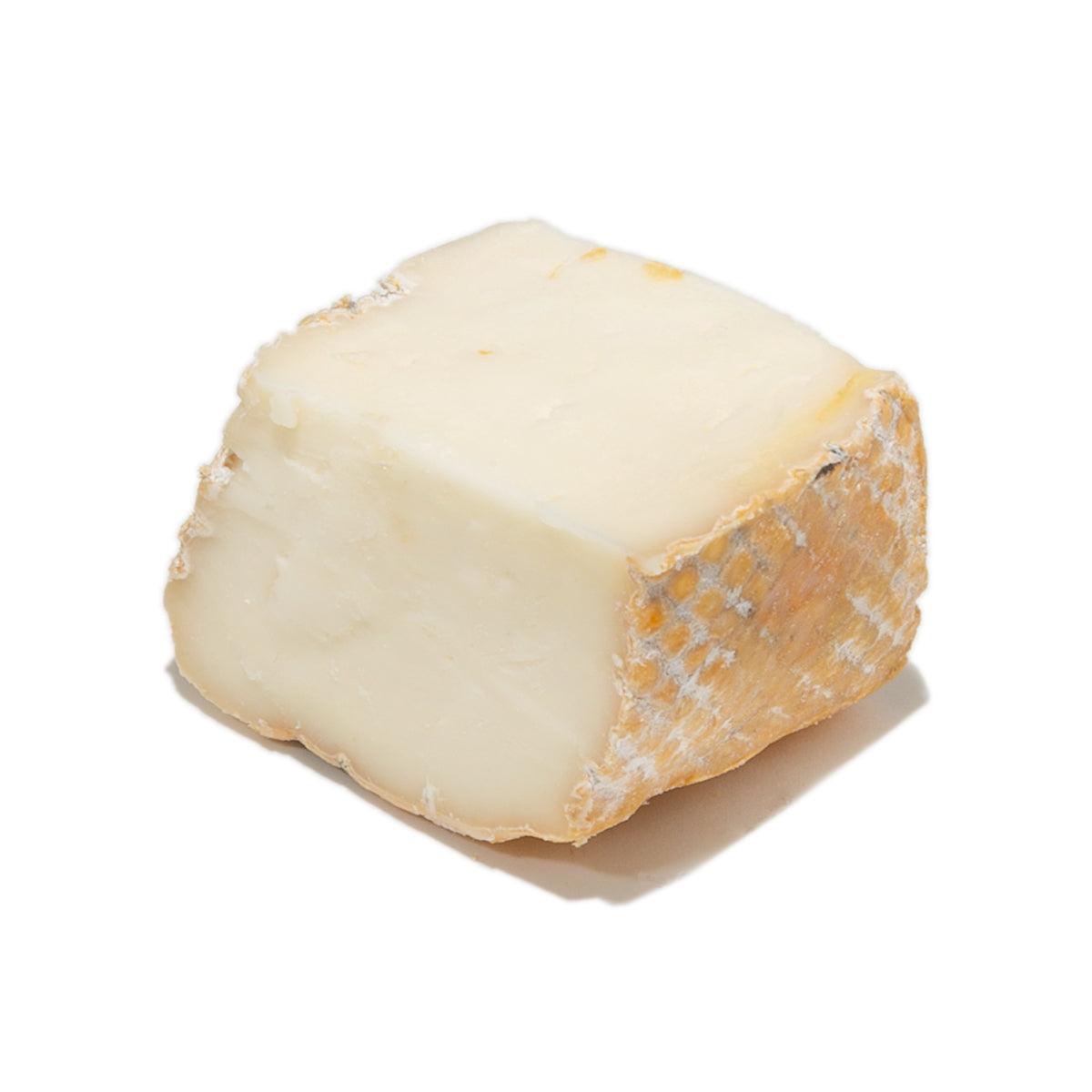 Taleggio DOP cheese wedge with pale creamy center and orange-brown rind