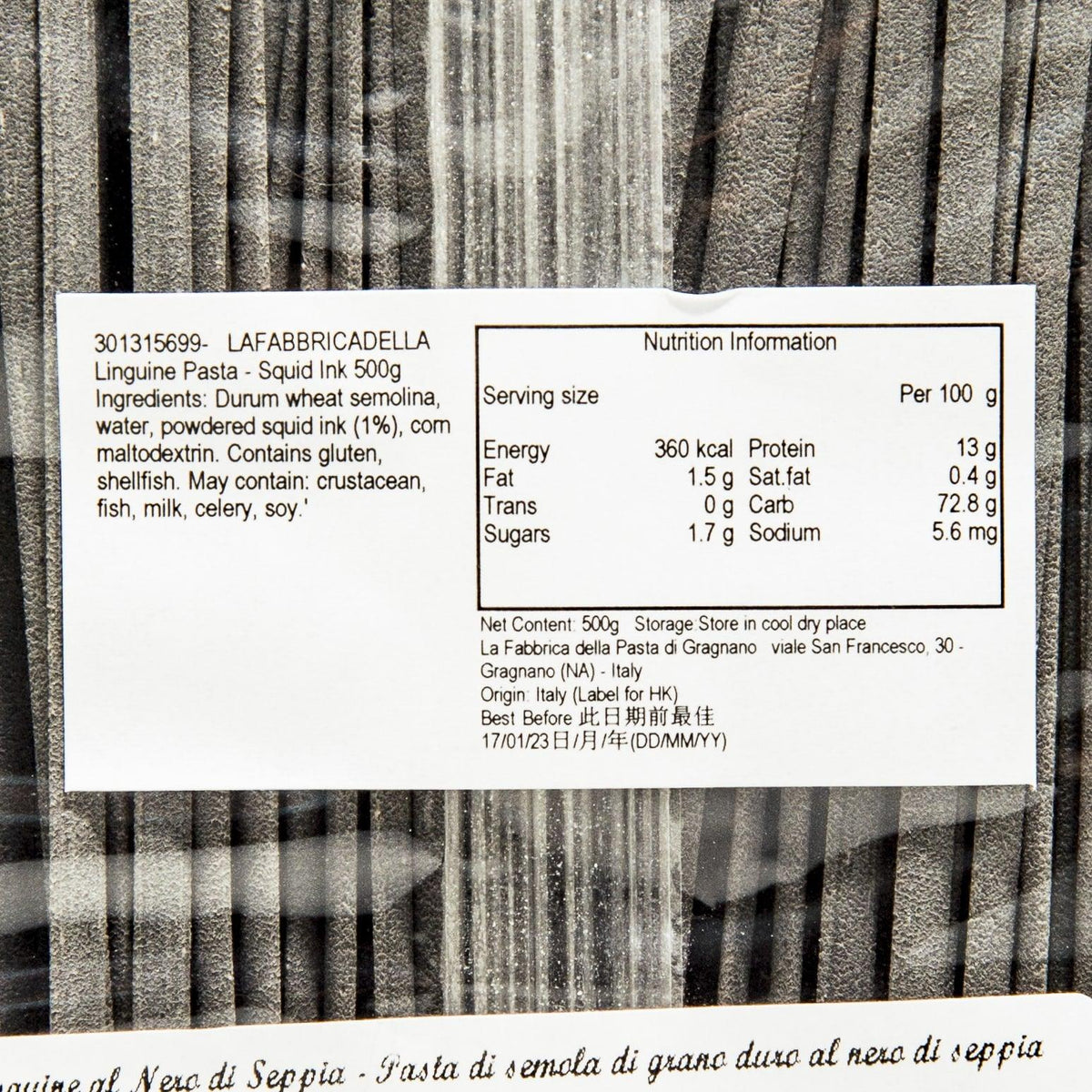 Squid ink linguine pasta, nutrition facts label over dark charcoal dried strands