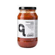 Fresh basil tomato sauce jar, glass with black lid, red sauce with basil flecks