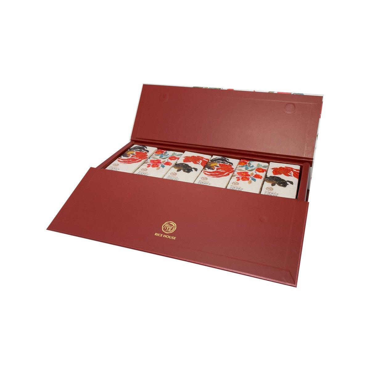 Opened rice gift box showing six small rice packages with floral animal design