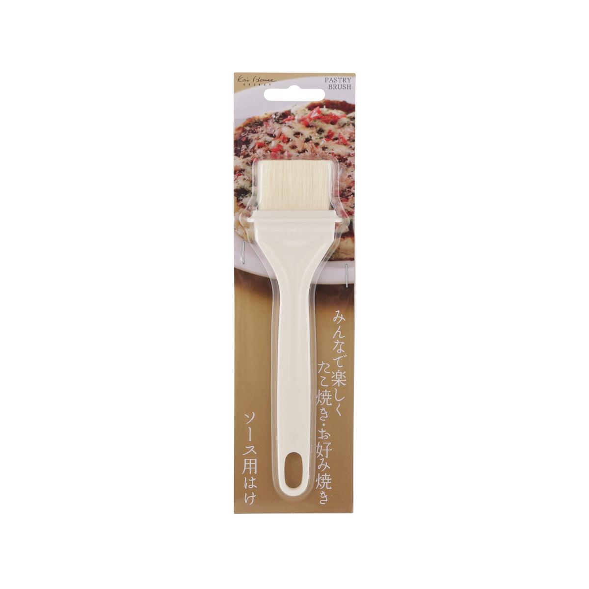 KAI pastry brush with pale bristles and angled head, packaged