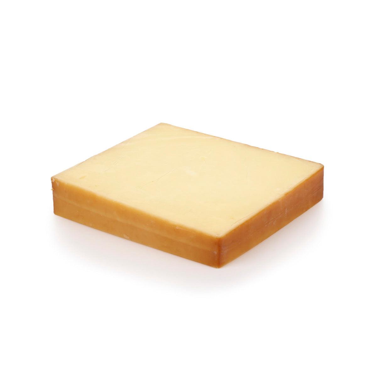 Smoked cheddar cheese wedge, square cut, pale yellow with smooth rind